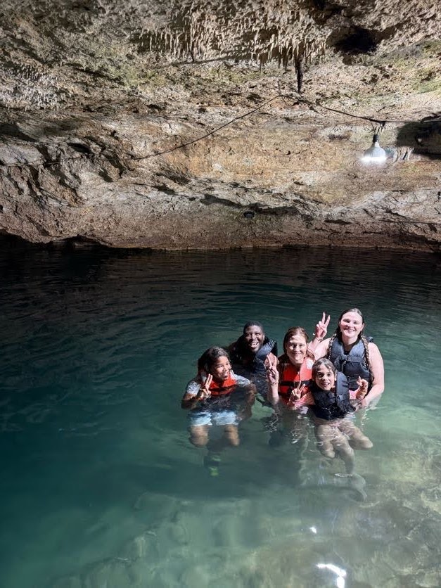 Kip's family swimming in a Yucatán cenote — the Cancún trip that started VoyageHQ